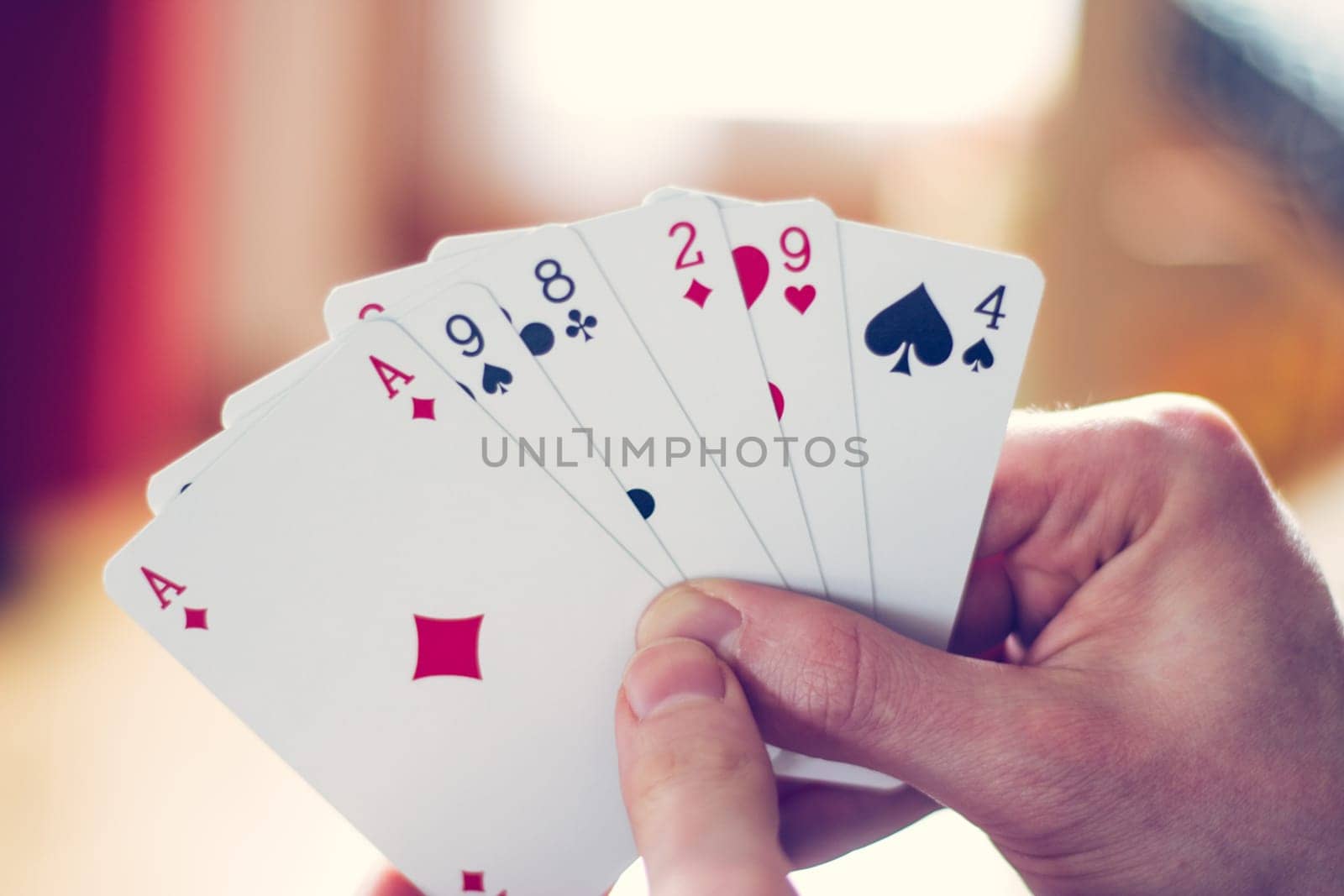 Young man is playing cards, cutout of his hands