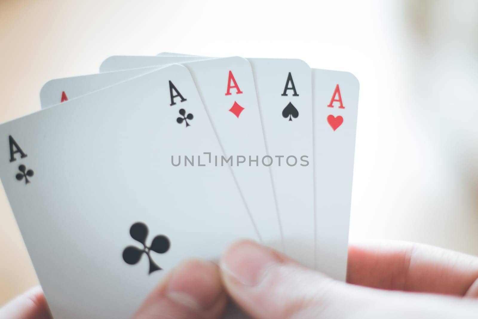 Young man is playing cards, cutout of his hands