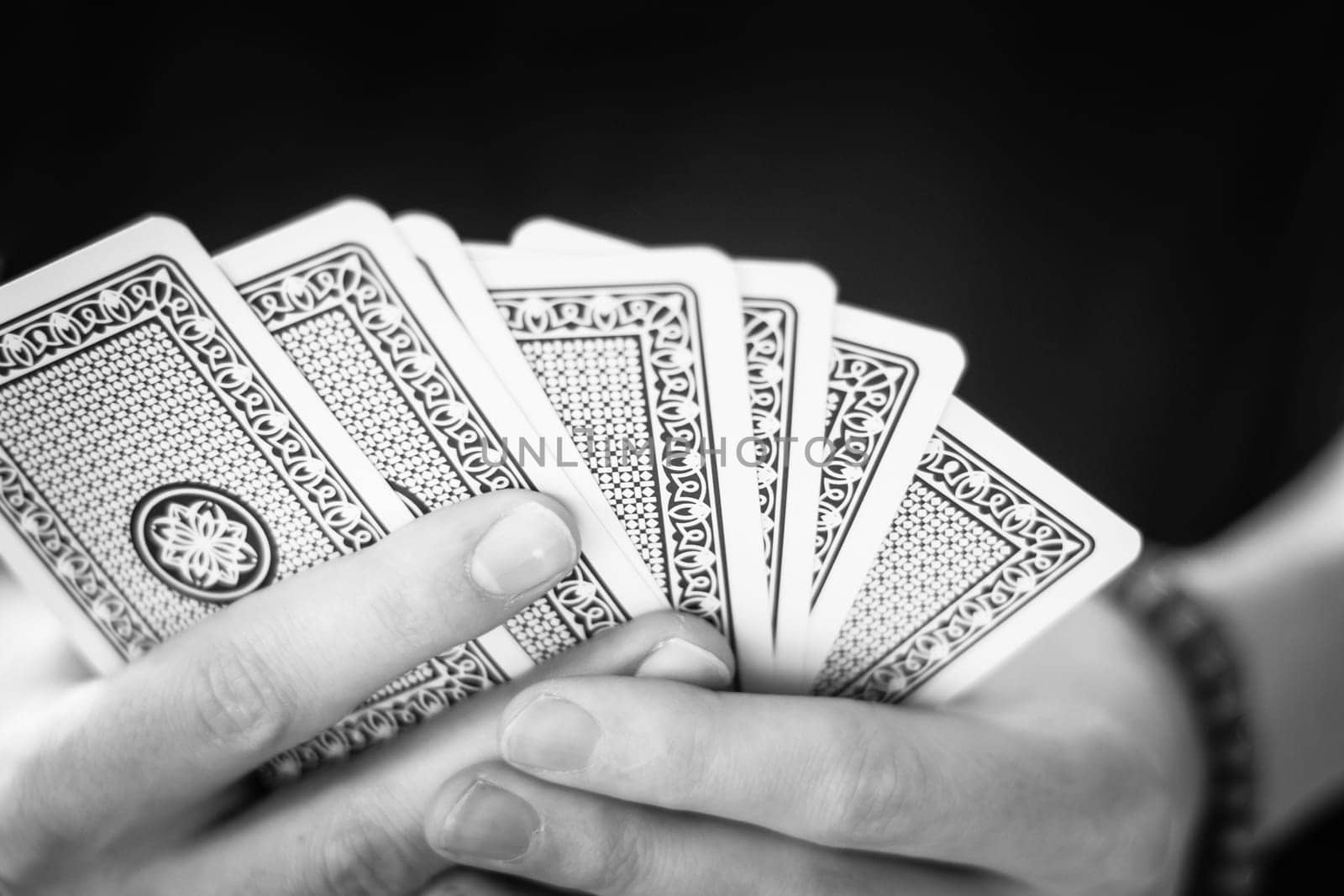 Young man is playing cards, cutout of his hands