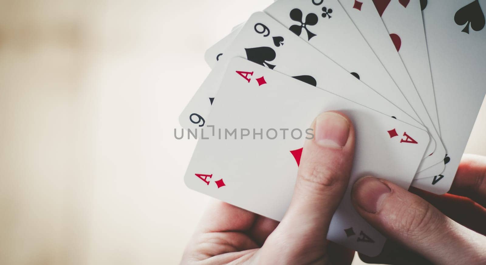 Young man is playing cards, cutout of his hands
