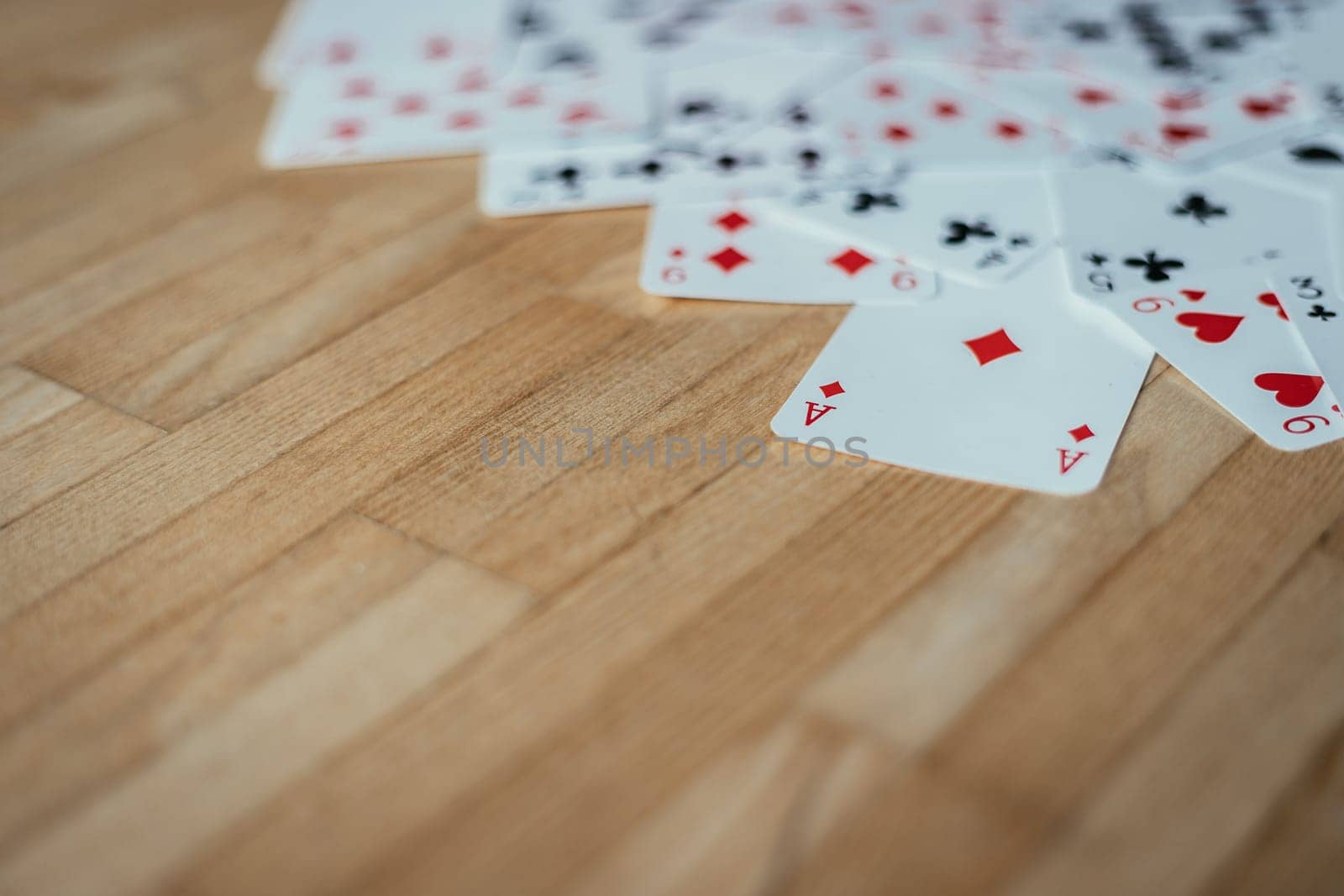 Gaming cards are lying on wood table. Playing cards at home, copy space.