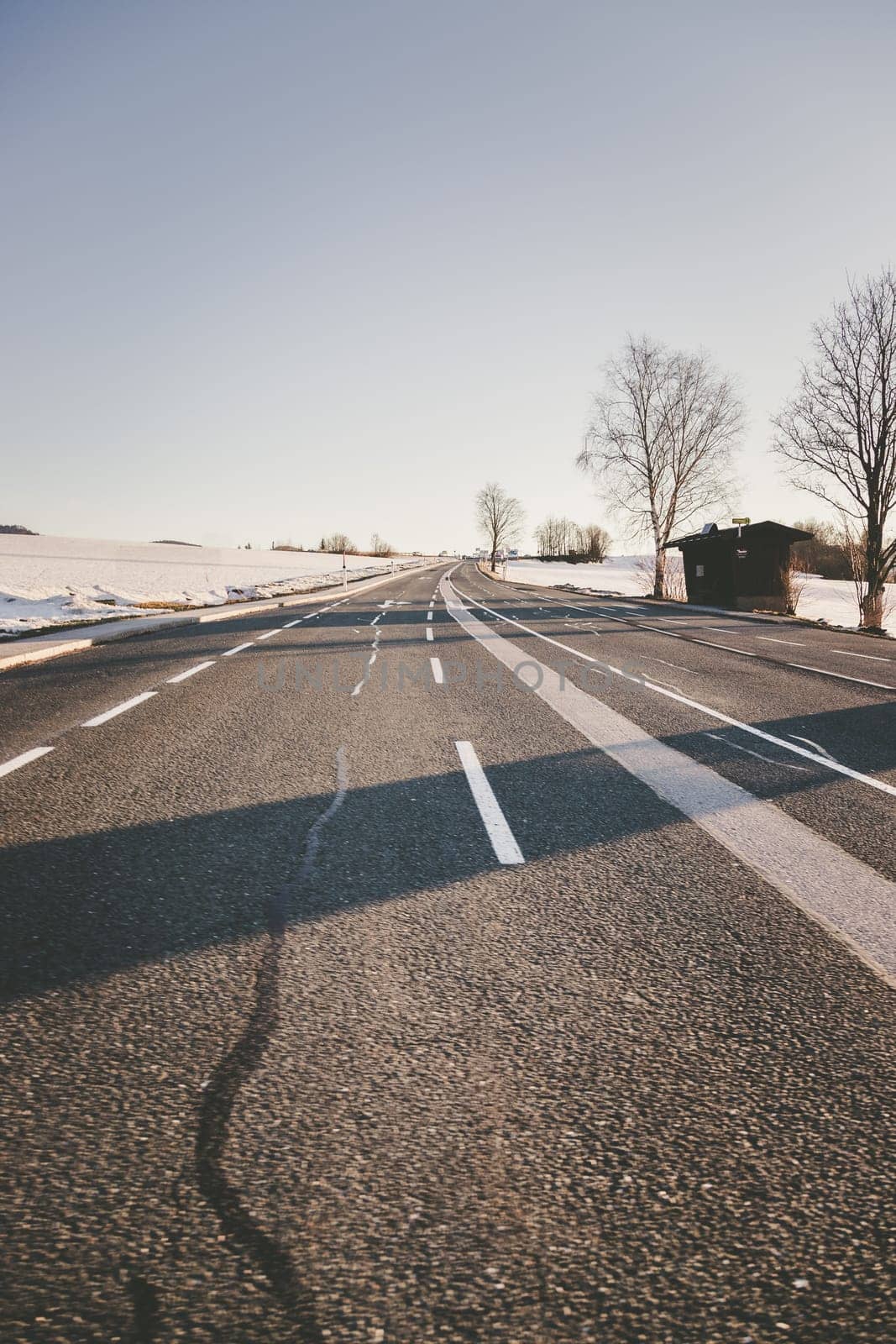 Black rough asphalt road in Austria, closeup
