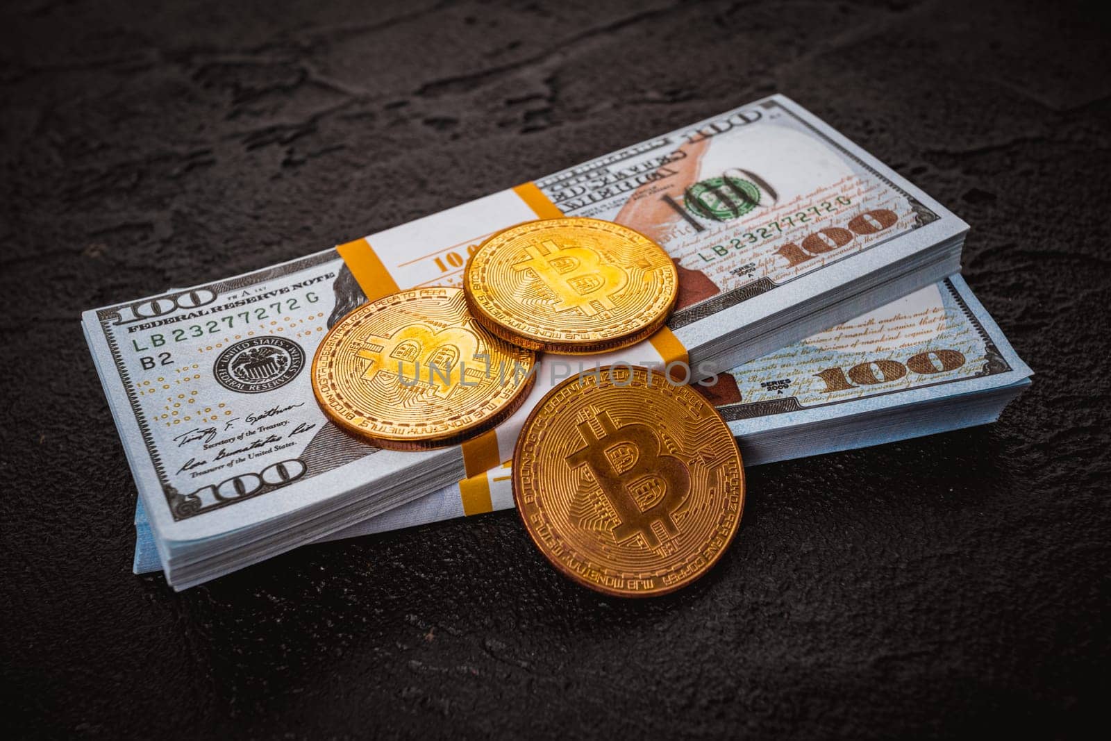 golden bitcoin metal coin on one US dollar bill