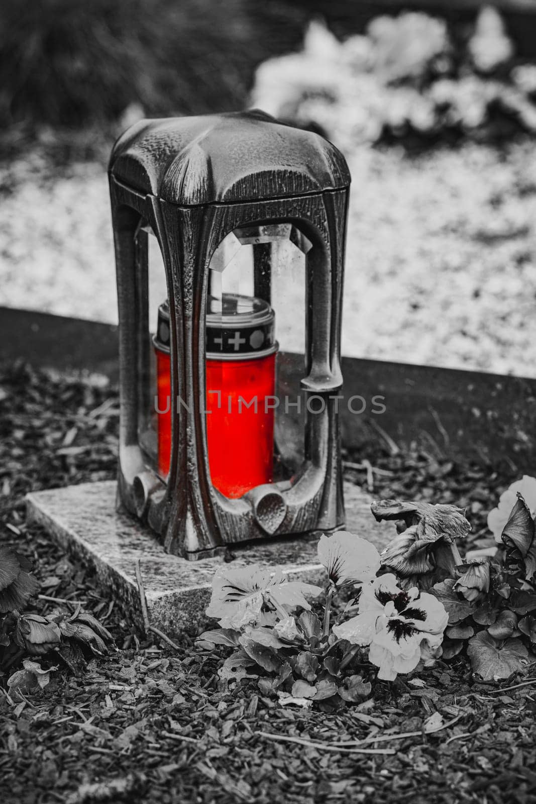 Old damaged grave lantern on a gravestone