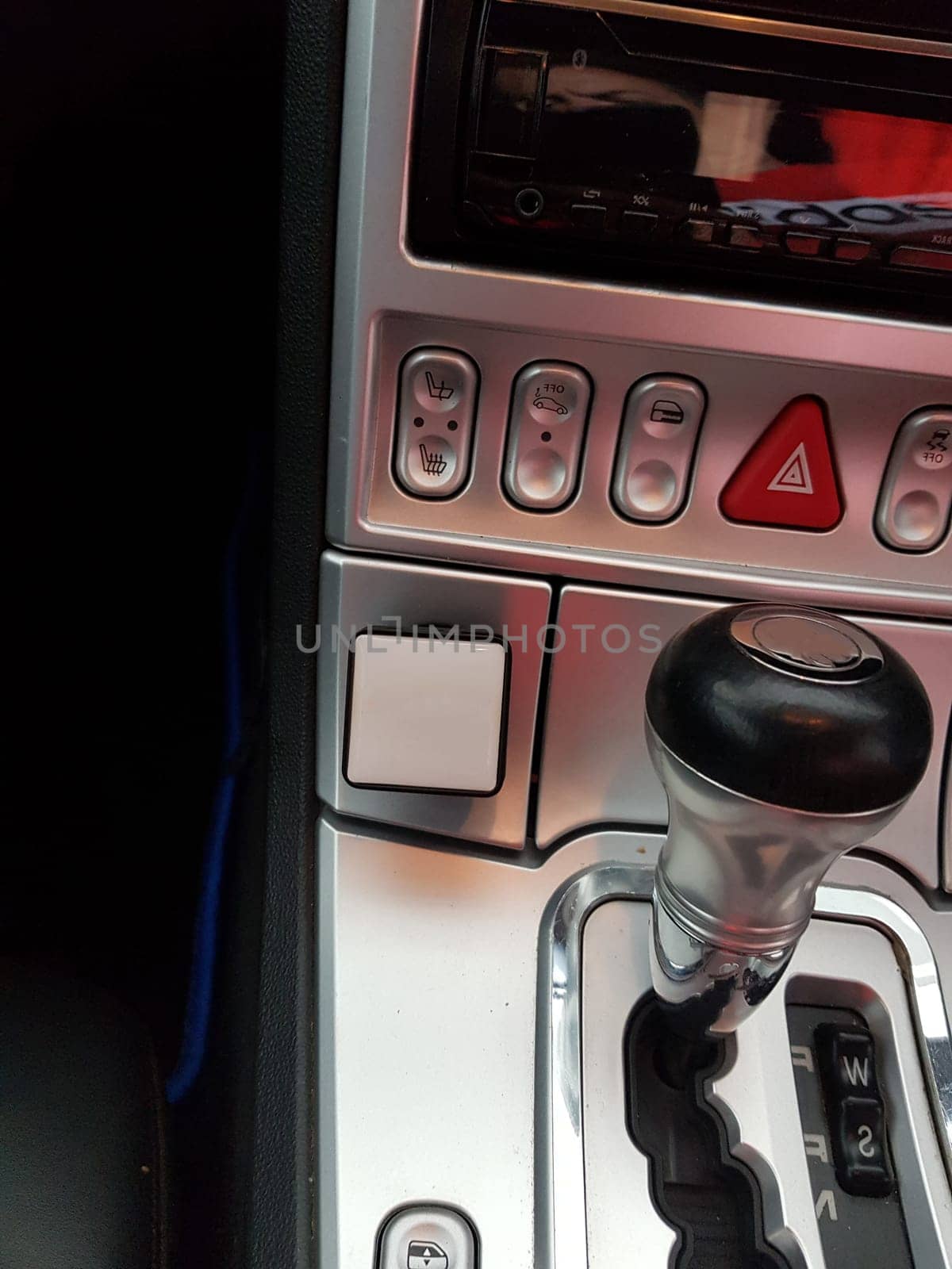 A look inside the interior of a sports car photographed on a public street.