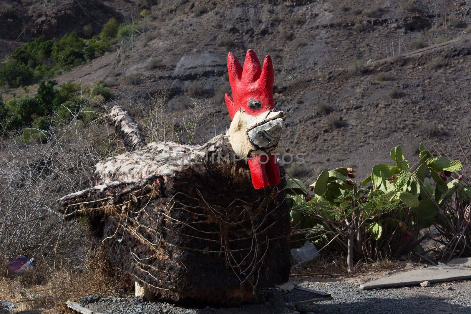 Giant rooster in the garden of Villa Mogan, the historic windmill Molino de Viento, Mogan, Gran Canaria, Spain