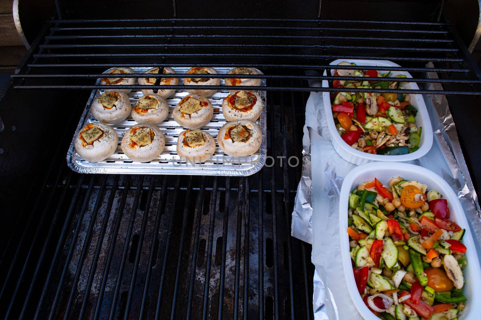 Grilled vegetables ( colorful bell pepper, zucchini, eggplant ) with basil and dry herbs on a plate over dark slate, stone, concrete or metal background.Top view.