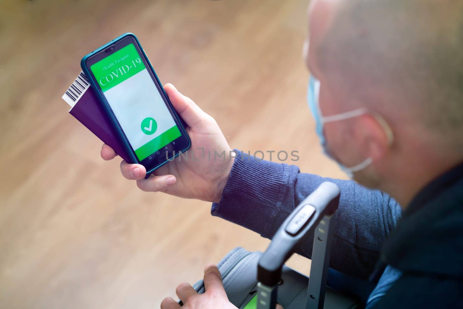 Vaccinated person using digital health passport app in mobile phone for travel during covid-19 pandemic