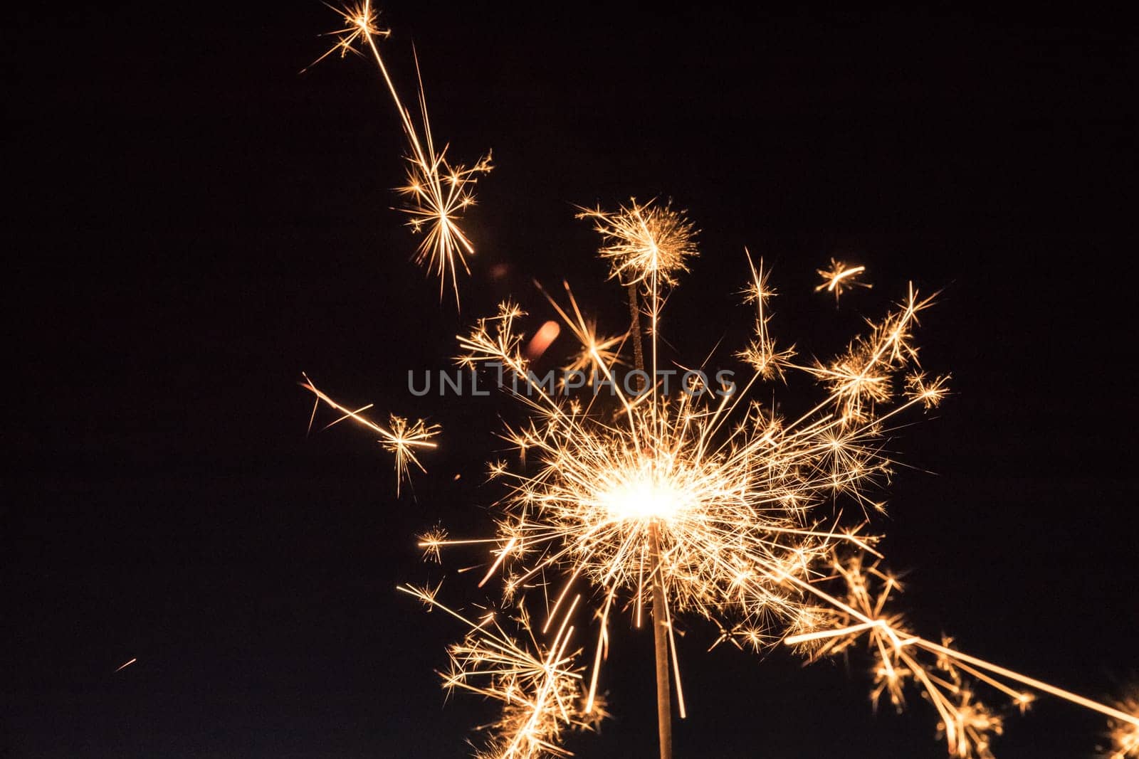 Christmas sparkler on black background. Sparks.