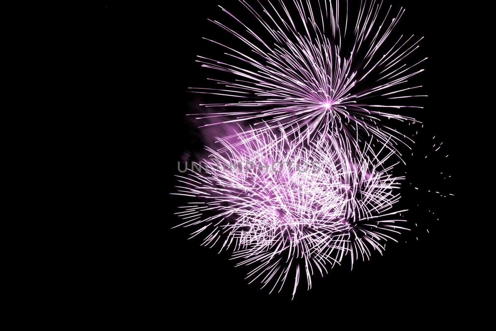 Premium entertainment magic star firework at e.g. New Years Eve or Independence Day party celebration. Black dark night background.