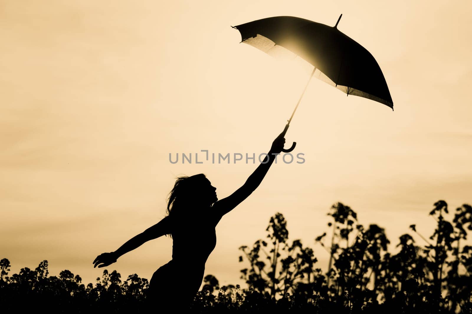 Nature girl at windy rainy day has adventure wanderlust. Wonderful scene of imagination power and departure to new horizons in youth.