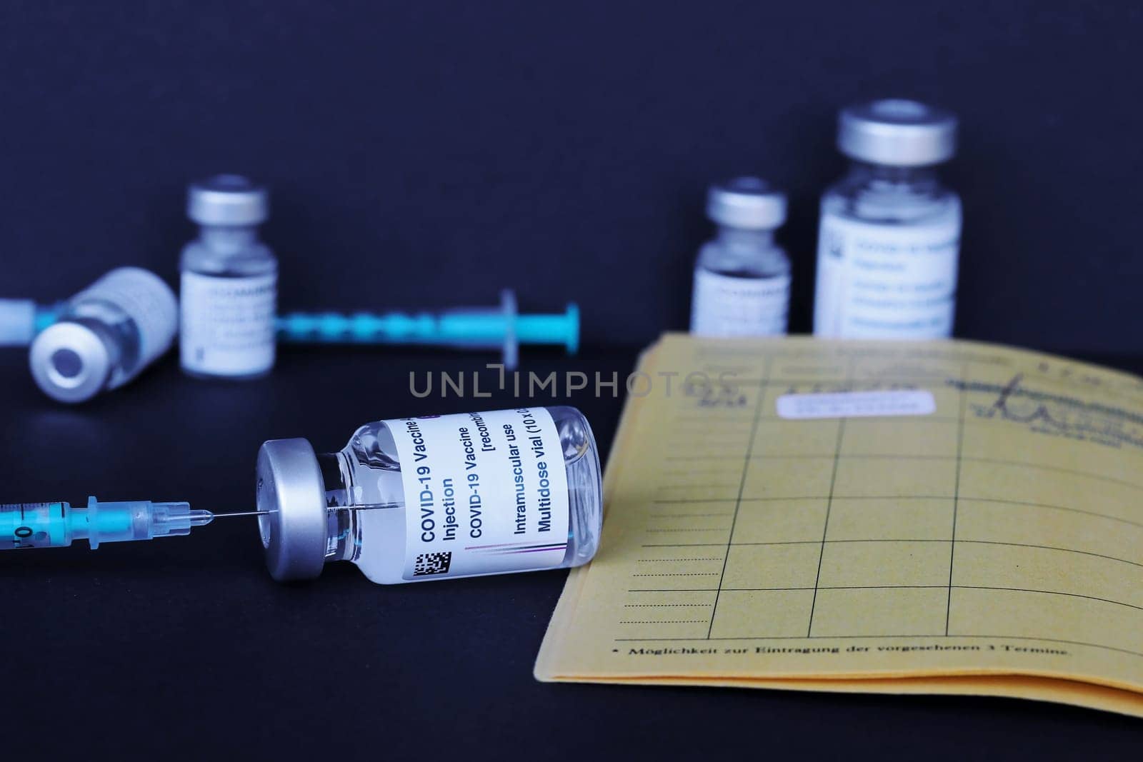 Corona Covid-19 vaccination with vaccination card, vaccination bottles and syringes