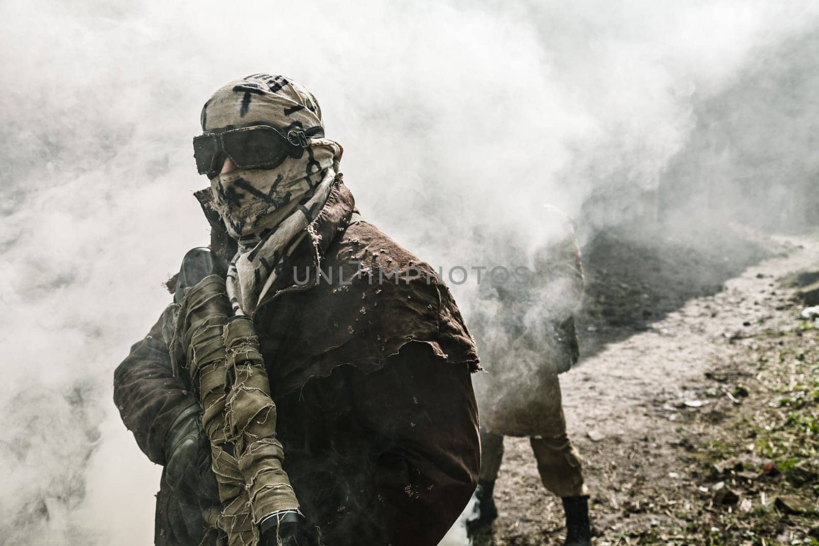 Nuclear post-apocalypse. Survivors in tatters and gas mask on the ruins of the destroyed city
