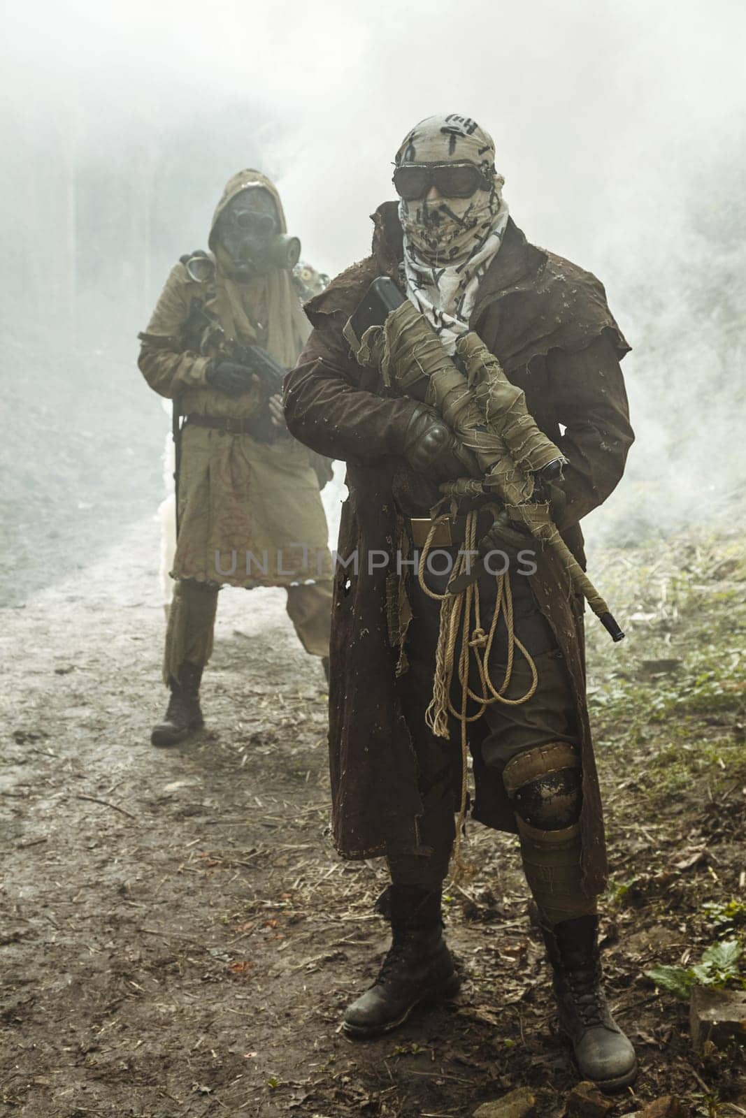 Nuclear post-apocalypse. Survivors in tatters and gas mask on the ruins of the destroyed city