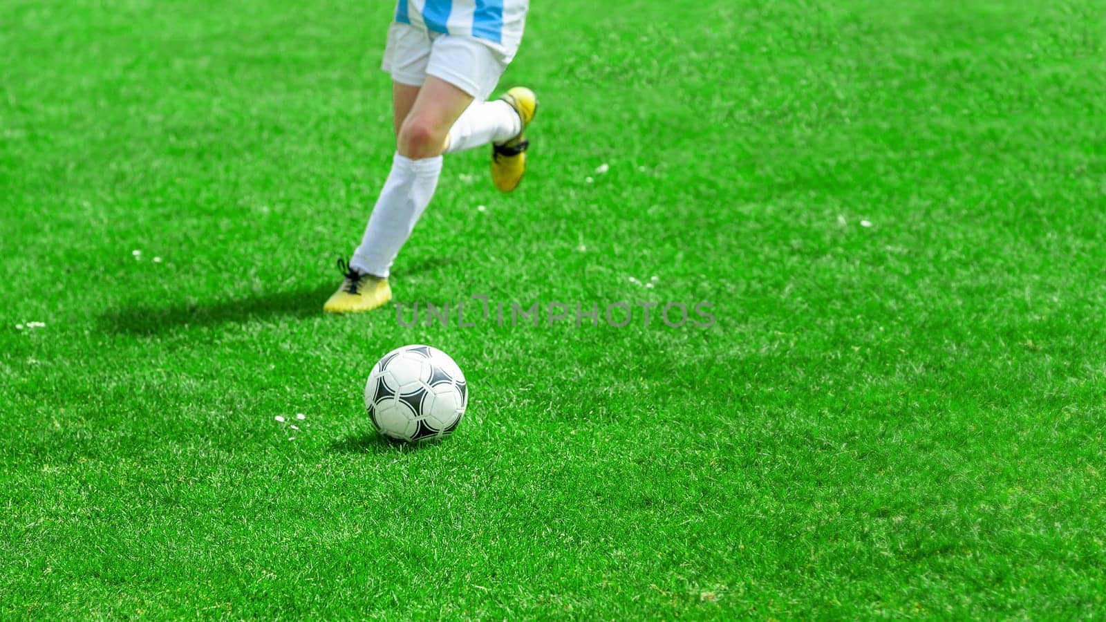 Football Player Compete For a Ball. Children Playing Sports on Grass Pitch. Closeup Image of Youth Football Competition Match. detail photo