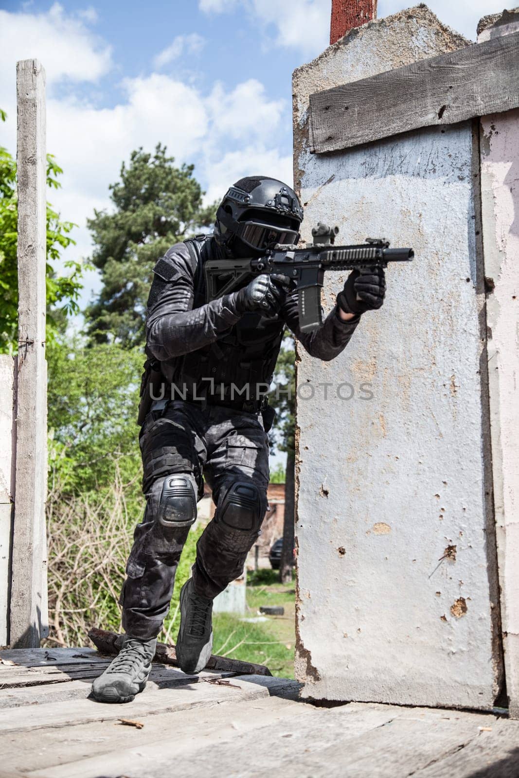 Spec ops police officer SWAT in black uniform in action
