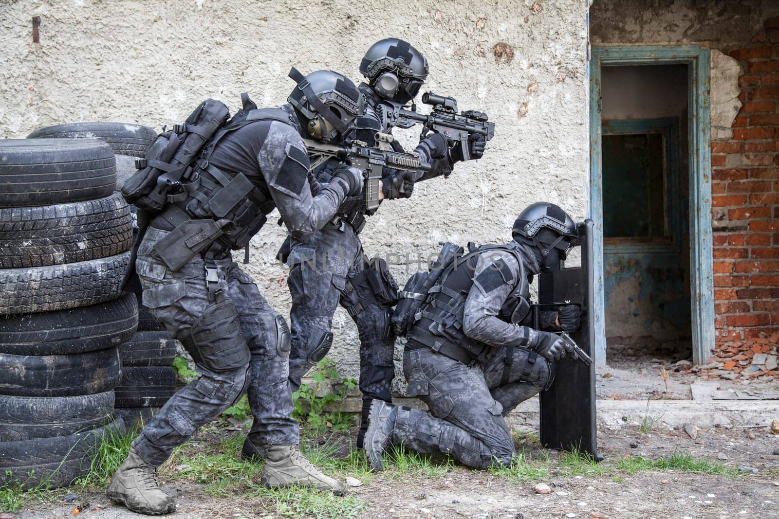 Spec ops police officers SWAT in black uniform in action