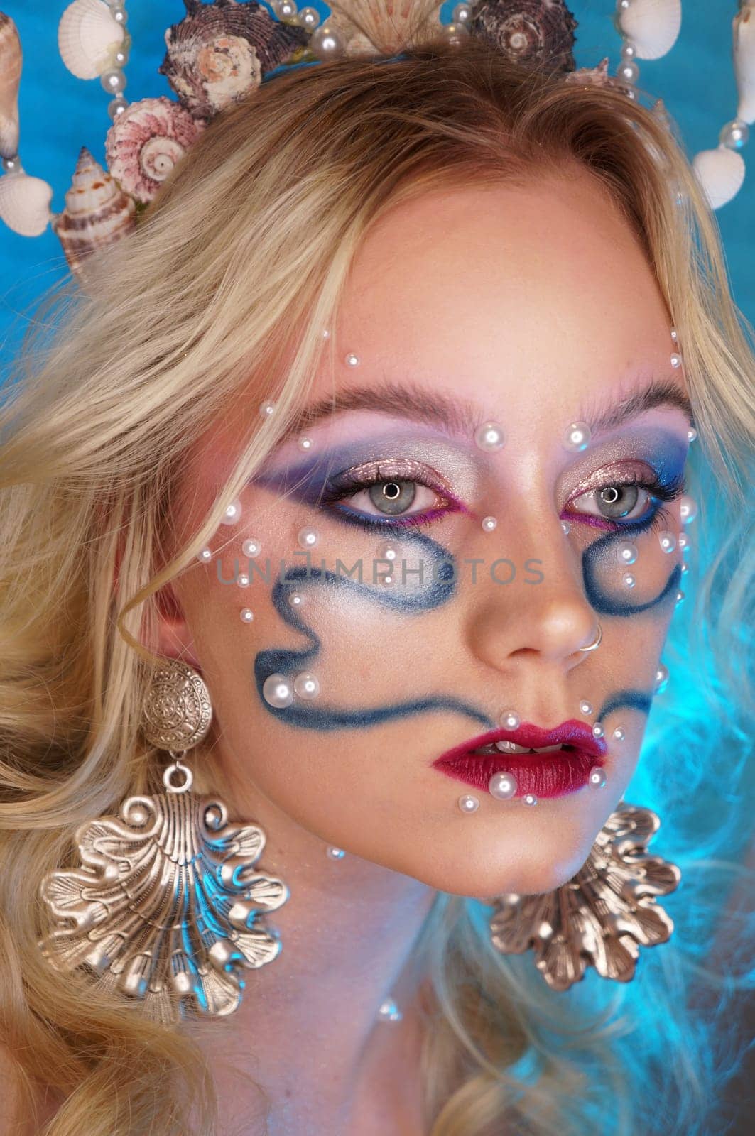 young woman with makeup and pearl jewellery