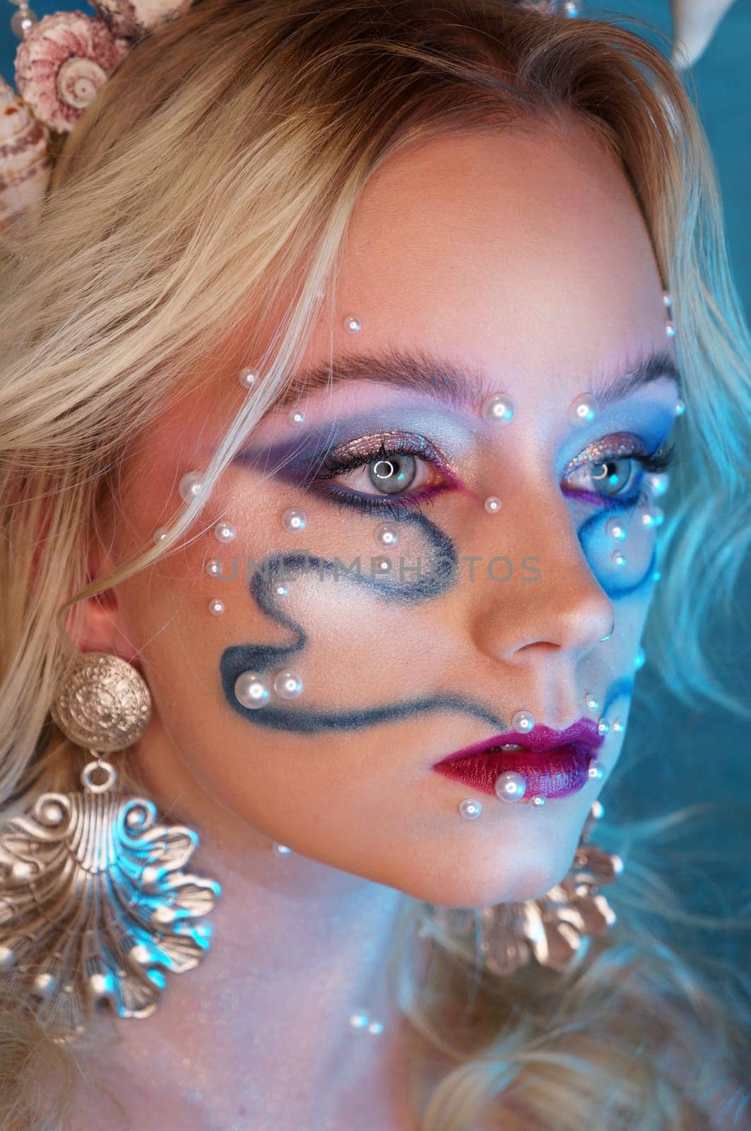 young woman with makeup and pearl jewellery
