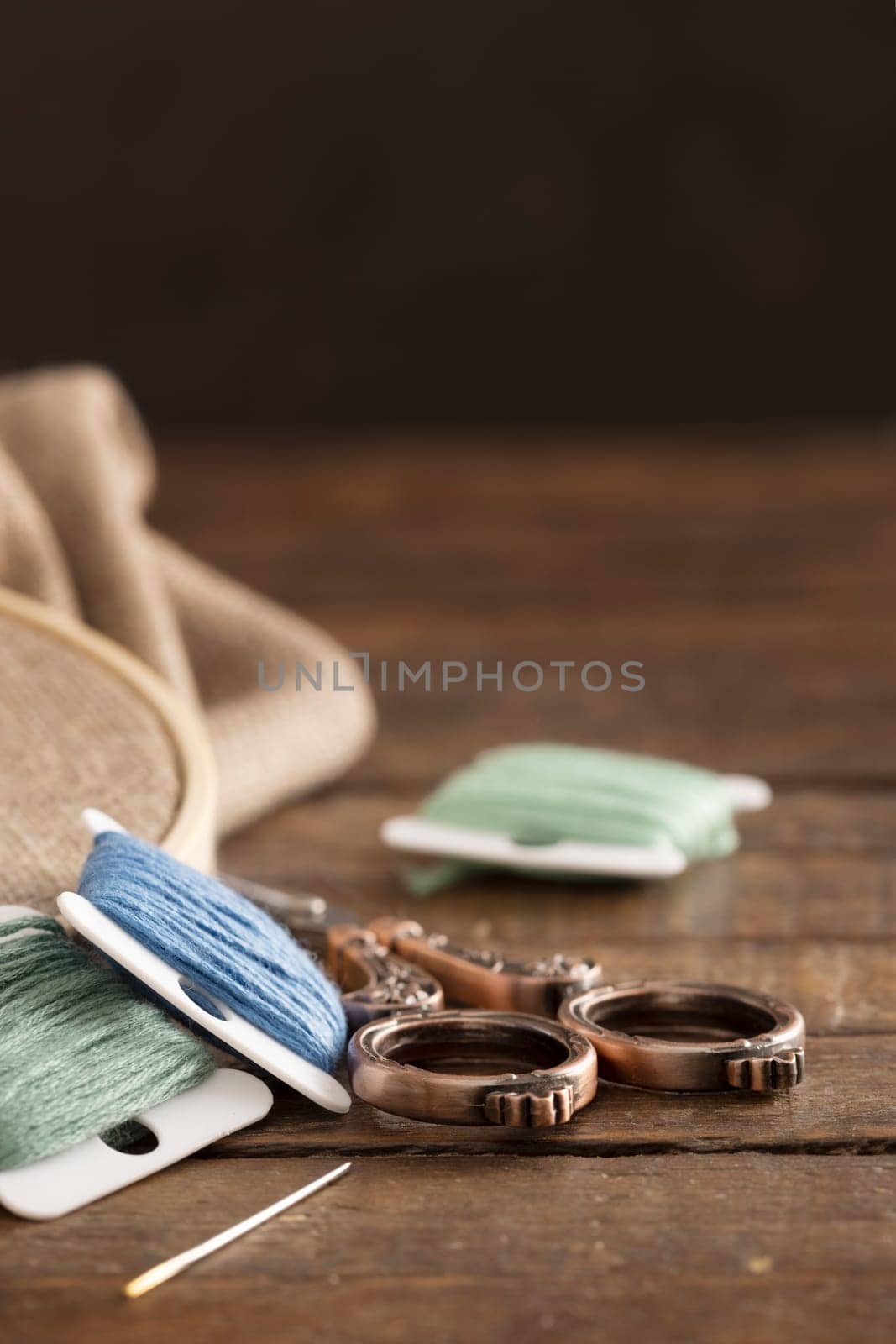 Colorful cotton embroidery floss with vintage style scissors vertical orientation with copy space.