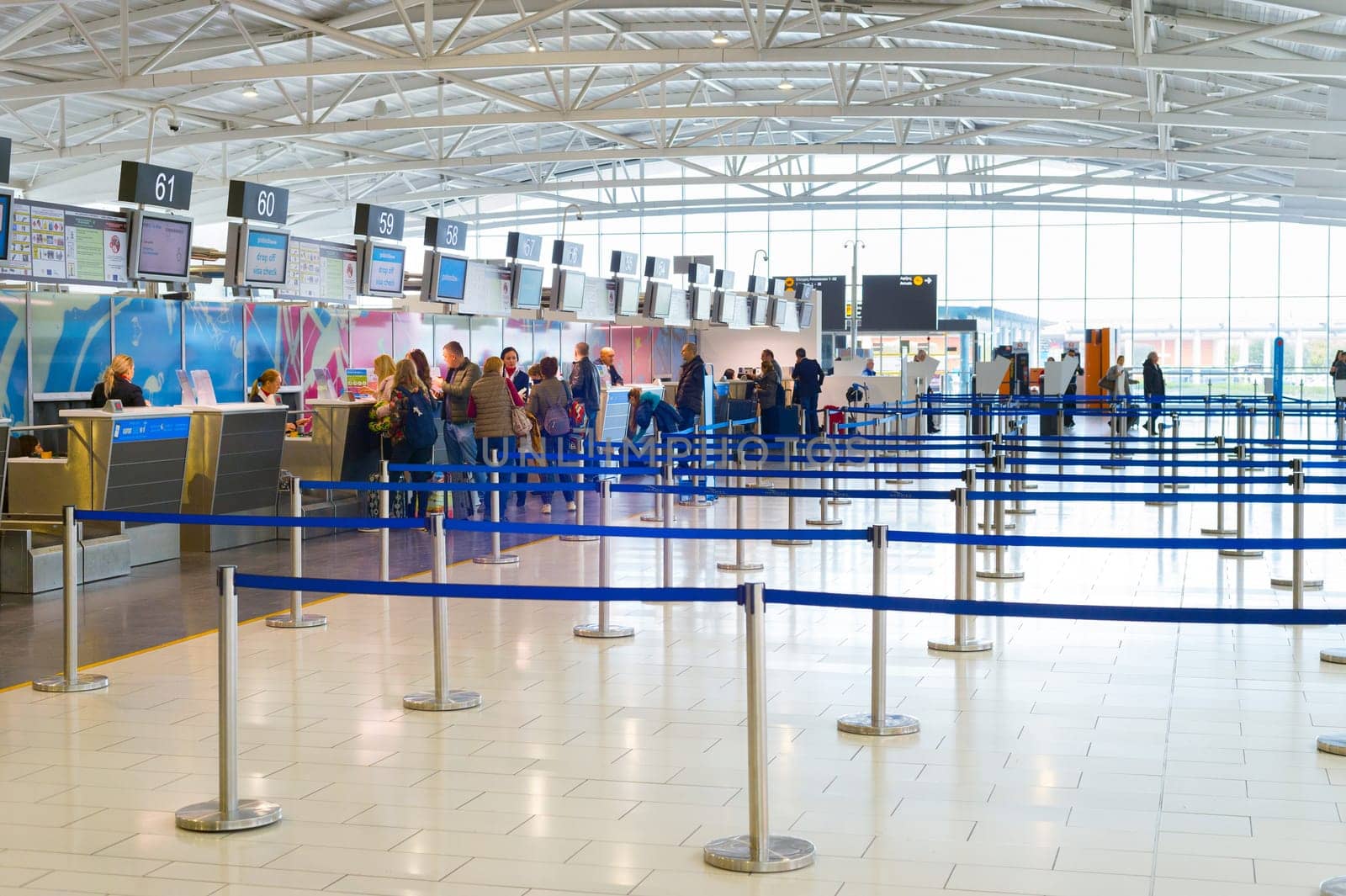 LARNACA, CYPRUS - FEBRUARY 21, 2019: Peopel at chekin desks and terminal of Larnaca International airport, modern interior