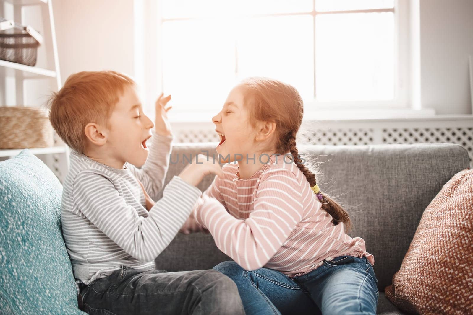 Two little kids having fight at home. Concept of the family relationship and friendship