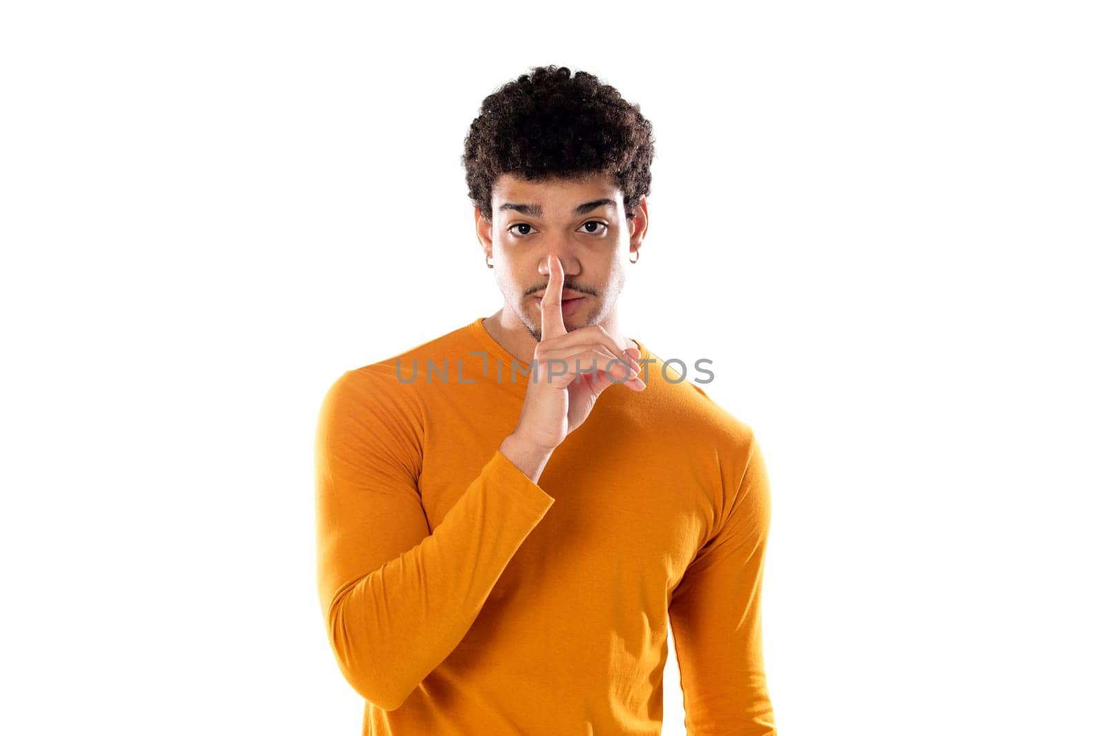 Cute african american man with afro hairstyle wearing a orange T-shirt isolated on a white background