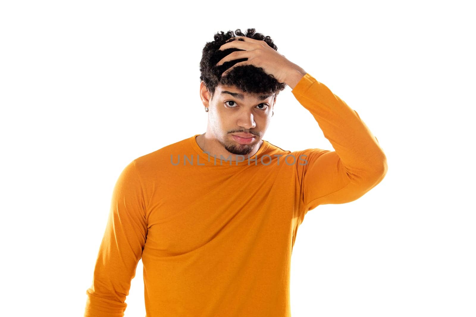 Smiling young man with afro hair wearing orange sweater isolated on a white background