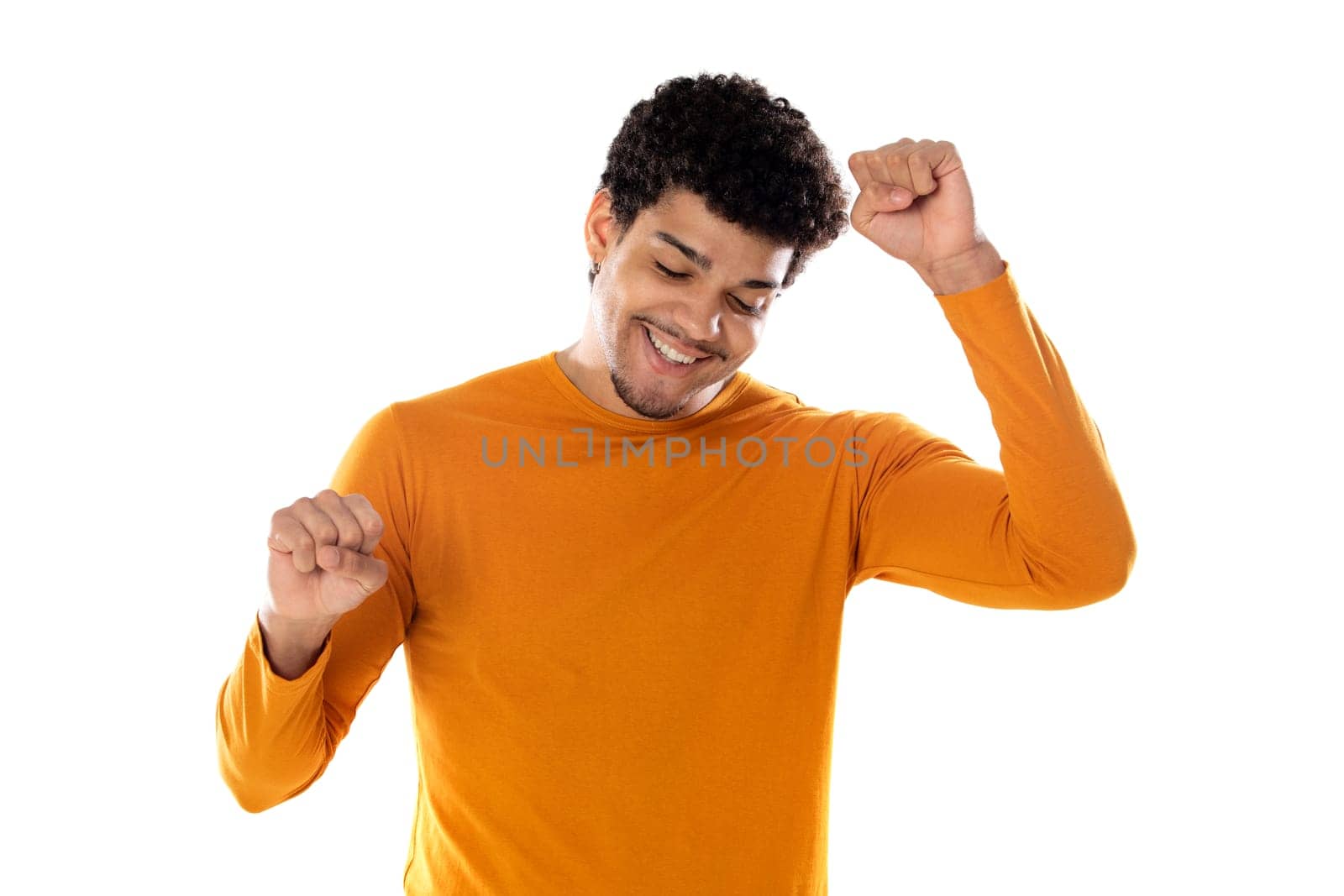 Excited afro guy wearing a orange sweater isolated on a white background