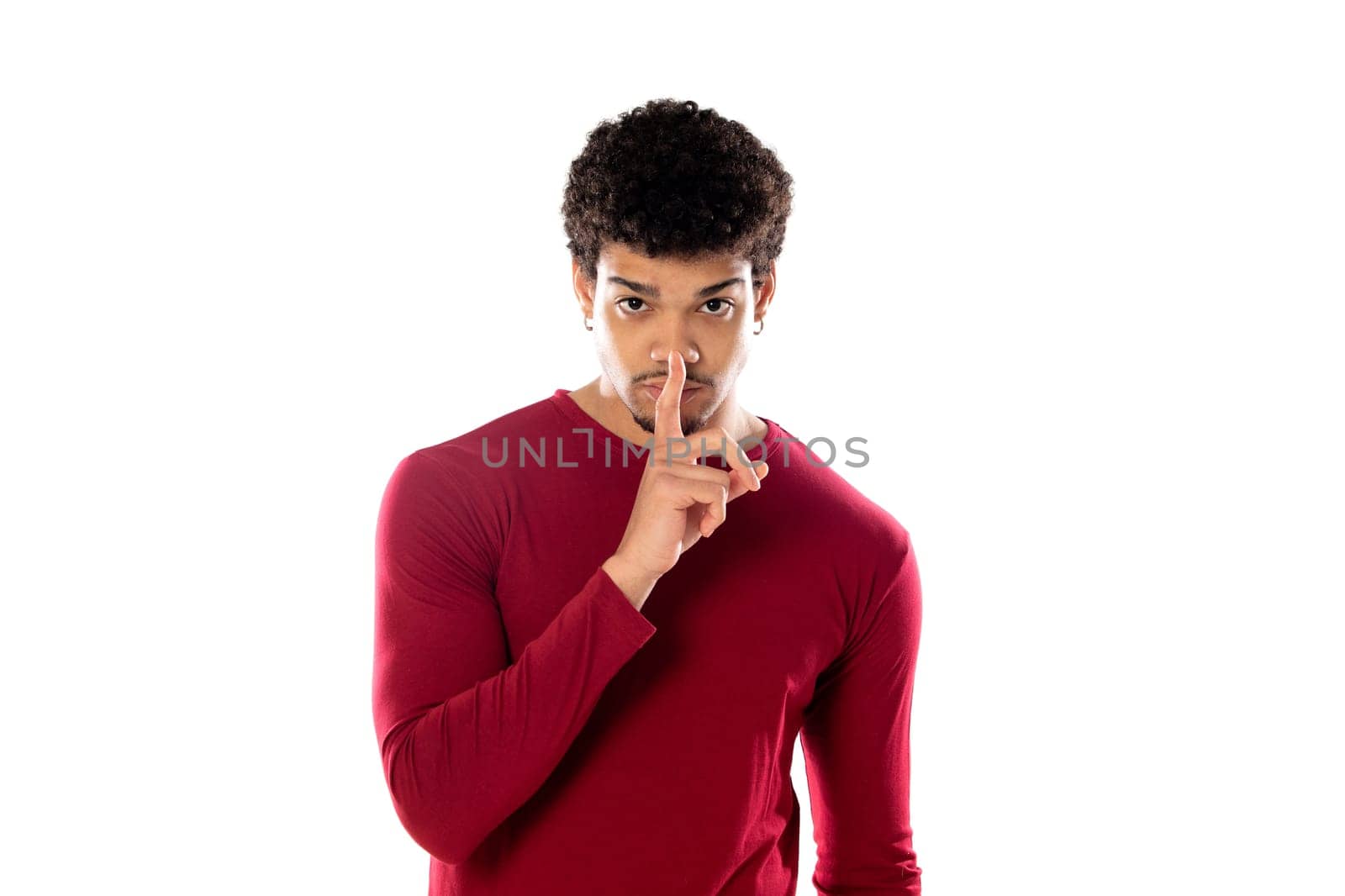 Cute african american man with afro hairstyle wearing a burgundy T-shirt isolated on a white background