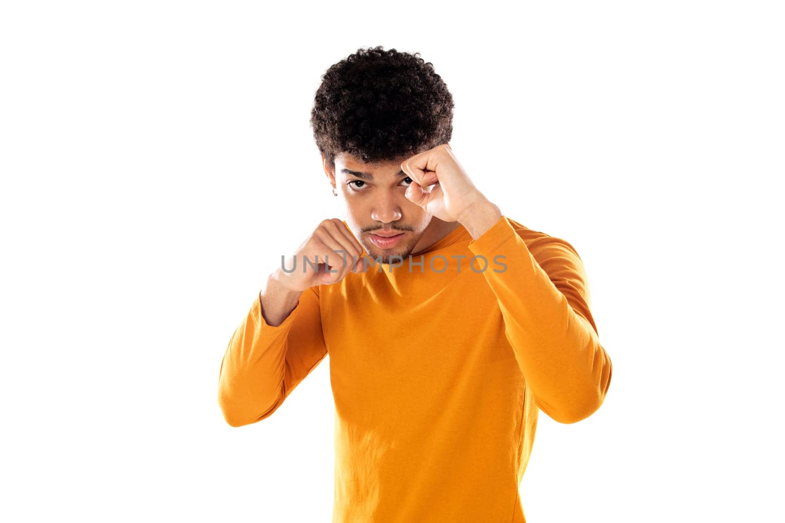 Cute african american man with afro hairstyle wearing a orange T-shirt isolated on a white background