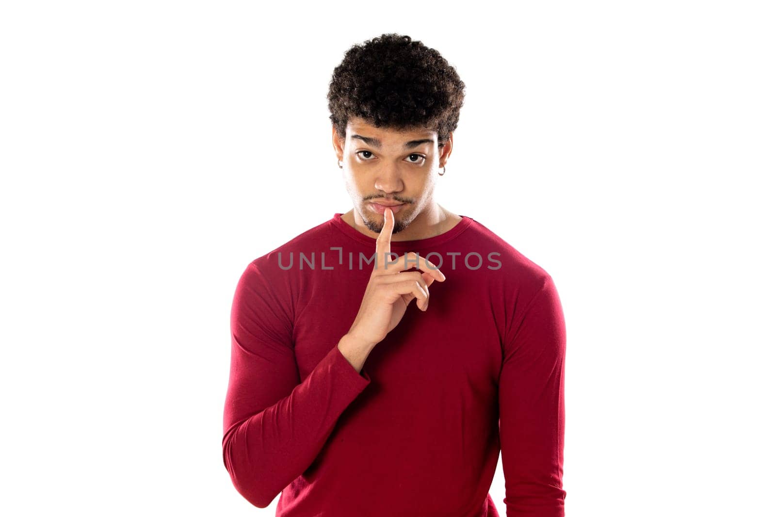 Cute african american man with afro hairstyle wearing a burgundy T-shirt isolated on a white background