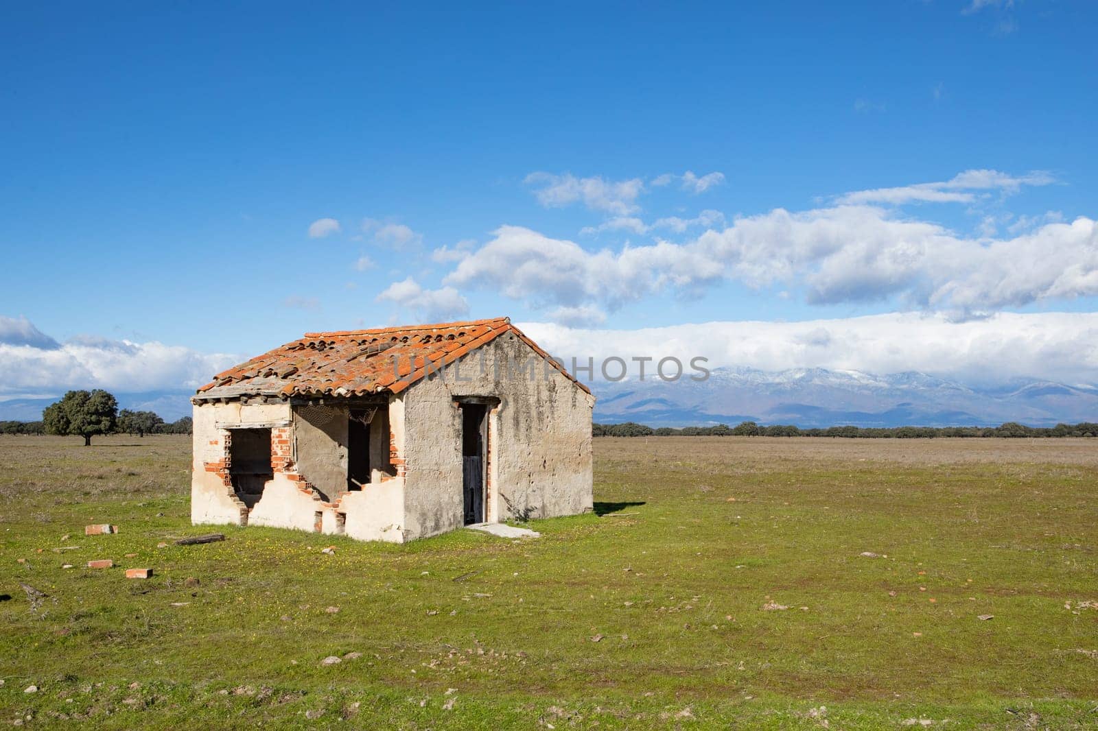 Abandoned and ruined house in the countryside. Stunning clouds in the sky