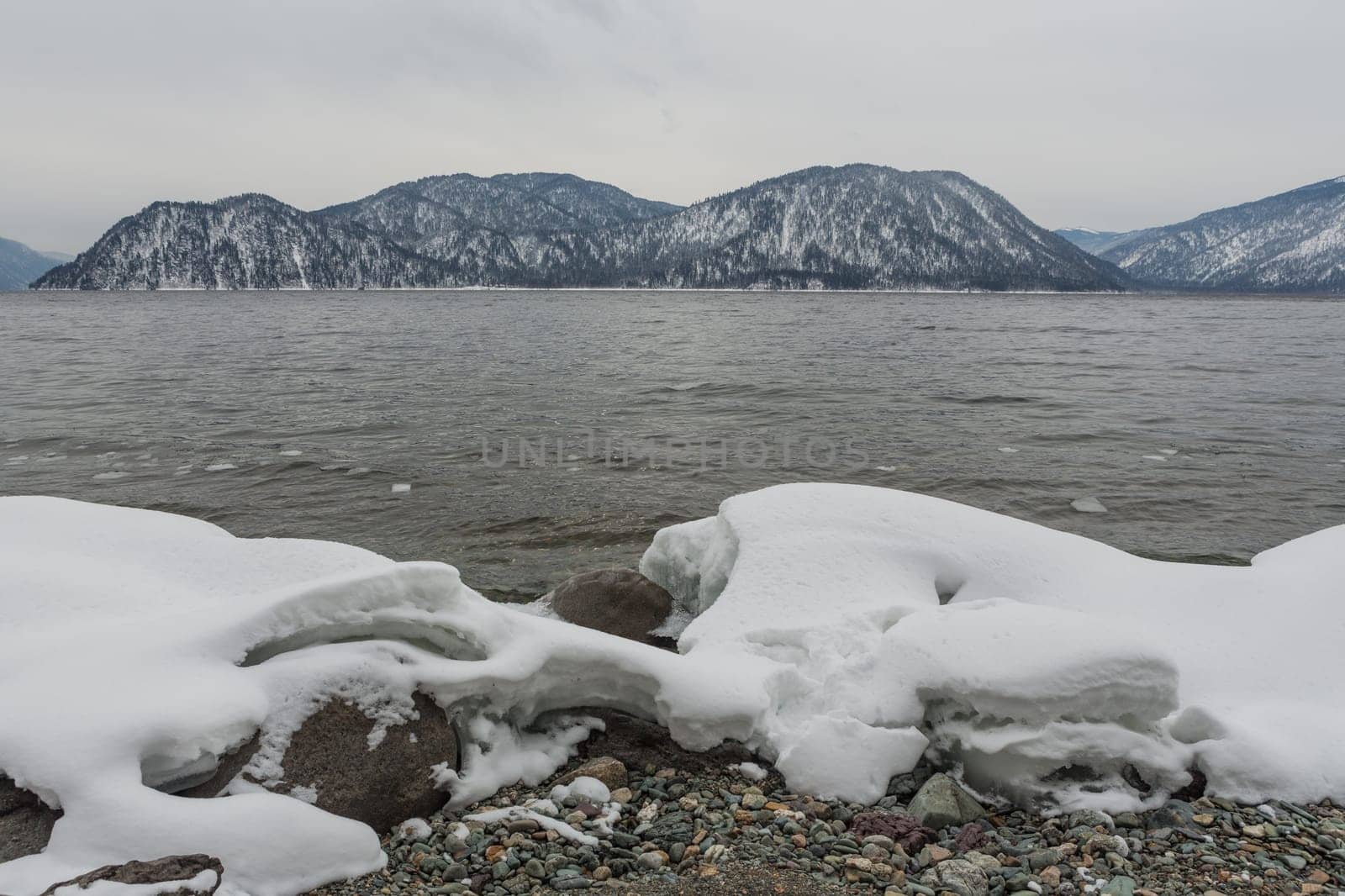 unfrozen Lake Teletskoye in winter. Russia Altai Krai.