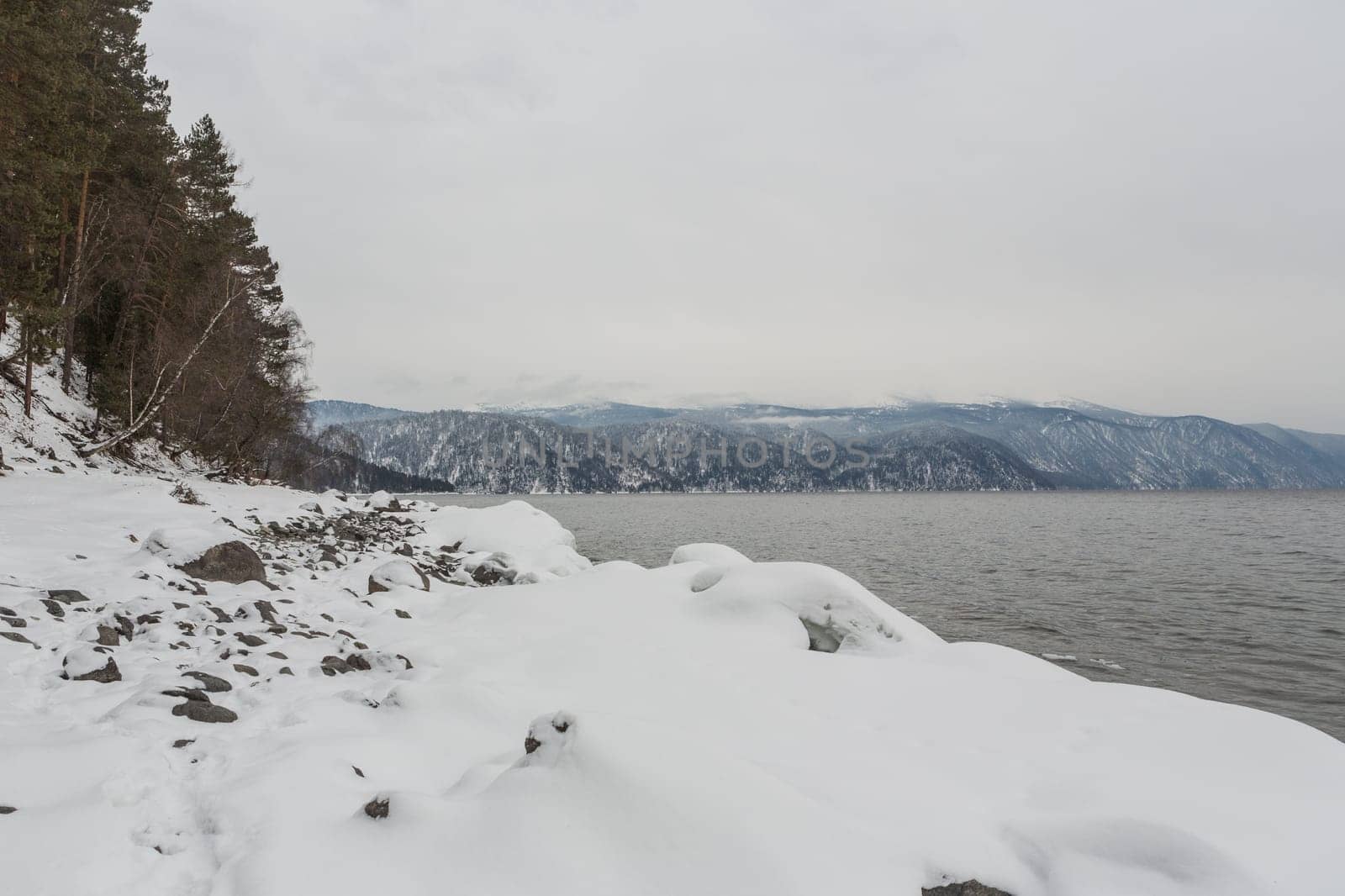 unfrozen Lake Teletskoye in winter. Russia Altai Krai.