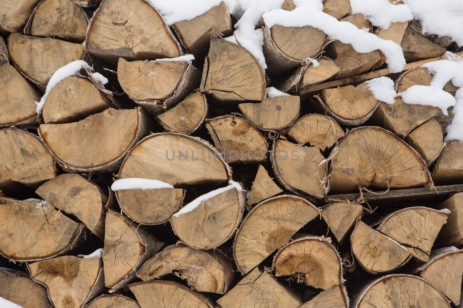 A pile of birch wood. prepared for the winter for kindling the village stove.