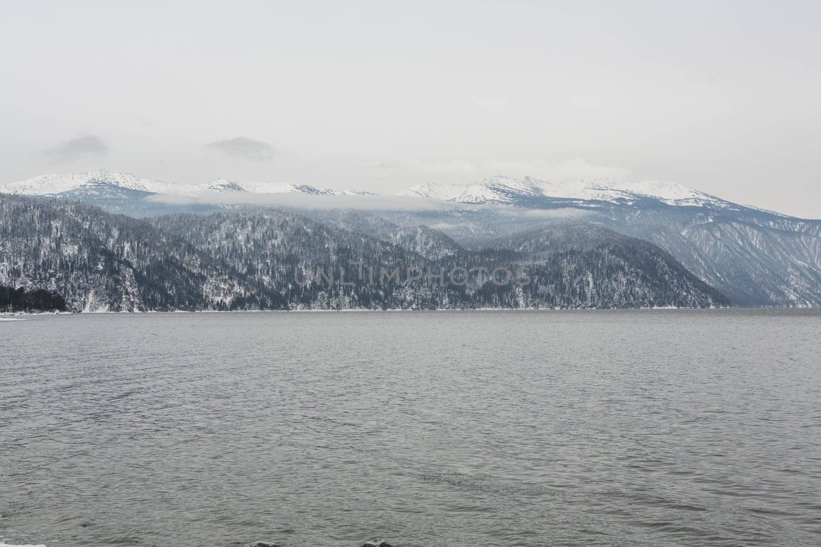 unfrozen Lake Teletskoye in winter. Russia Altai Krai.