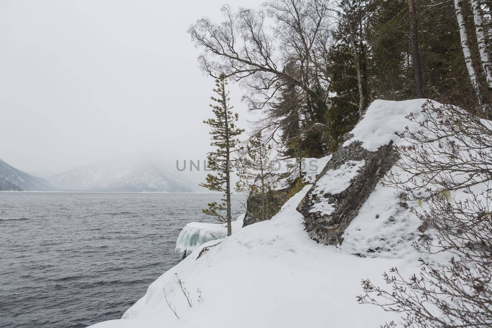 unfrozen Lake Teletskoye in winter. Russia Altai Krai.