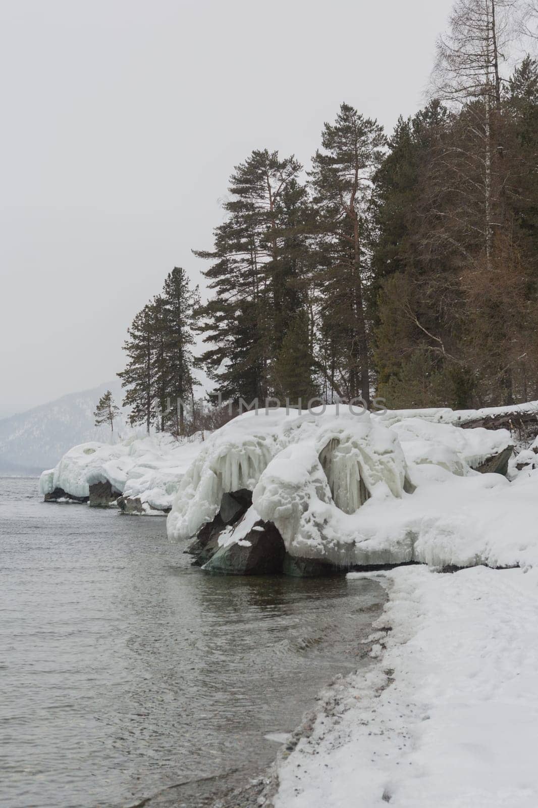 unfrozen Lake Teletskoye in winter. Russia Altai Krai.
