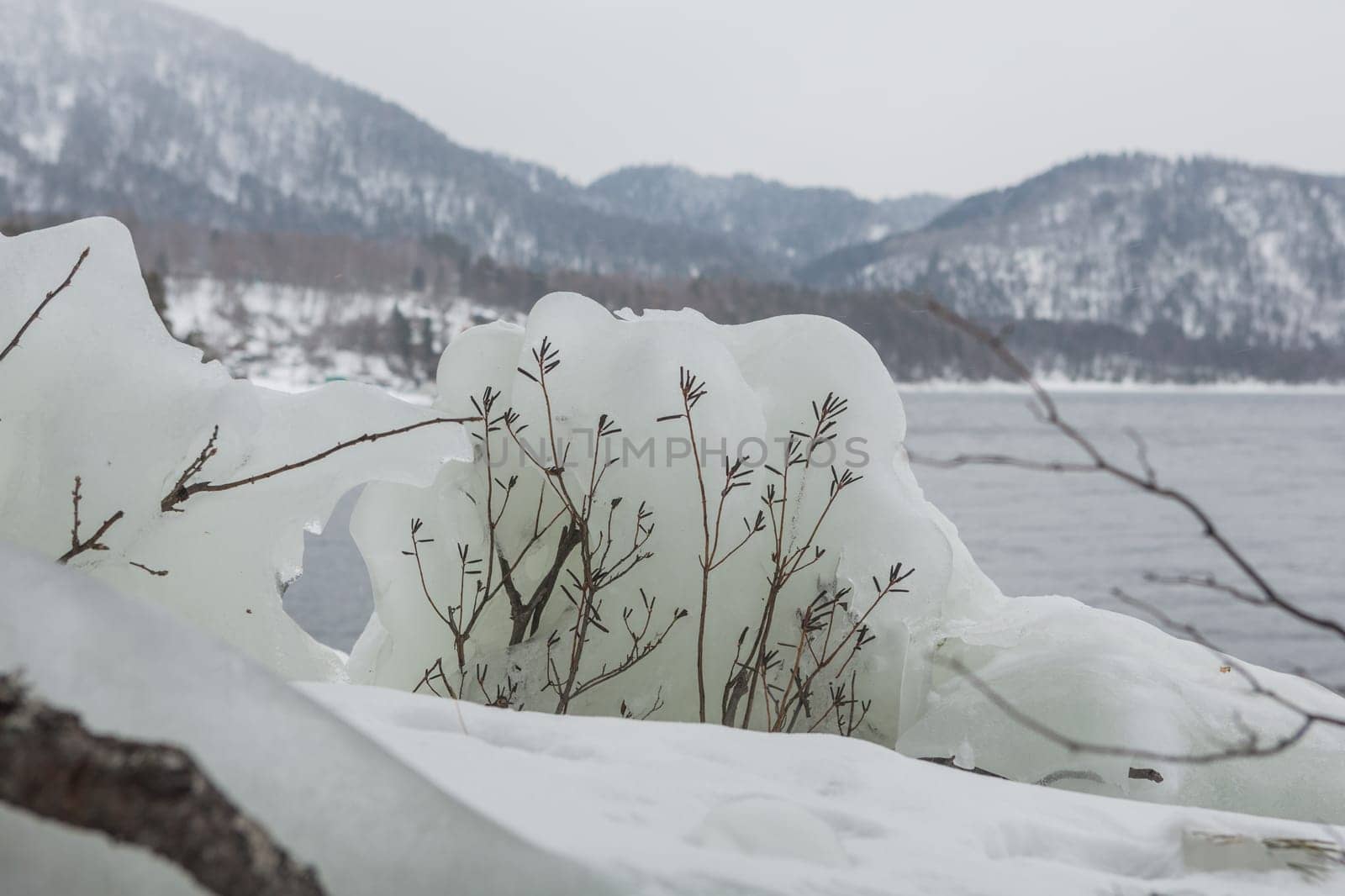 unfrozen Lake Teletskoye in winter. Russia Altai Krai.