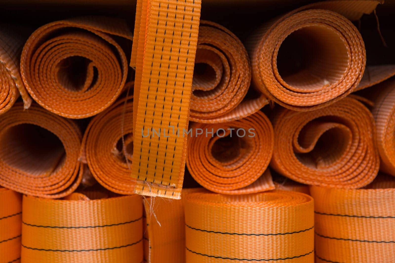 Industrial sewing machine sews a webbing sling. Manufacture of textile slings and tie straps