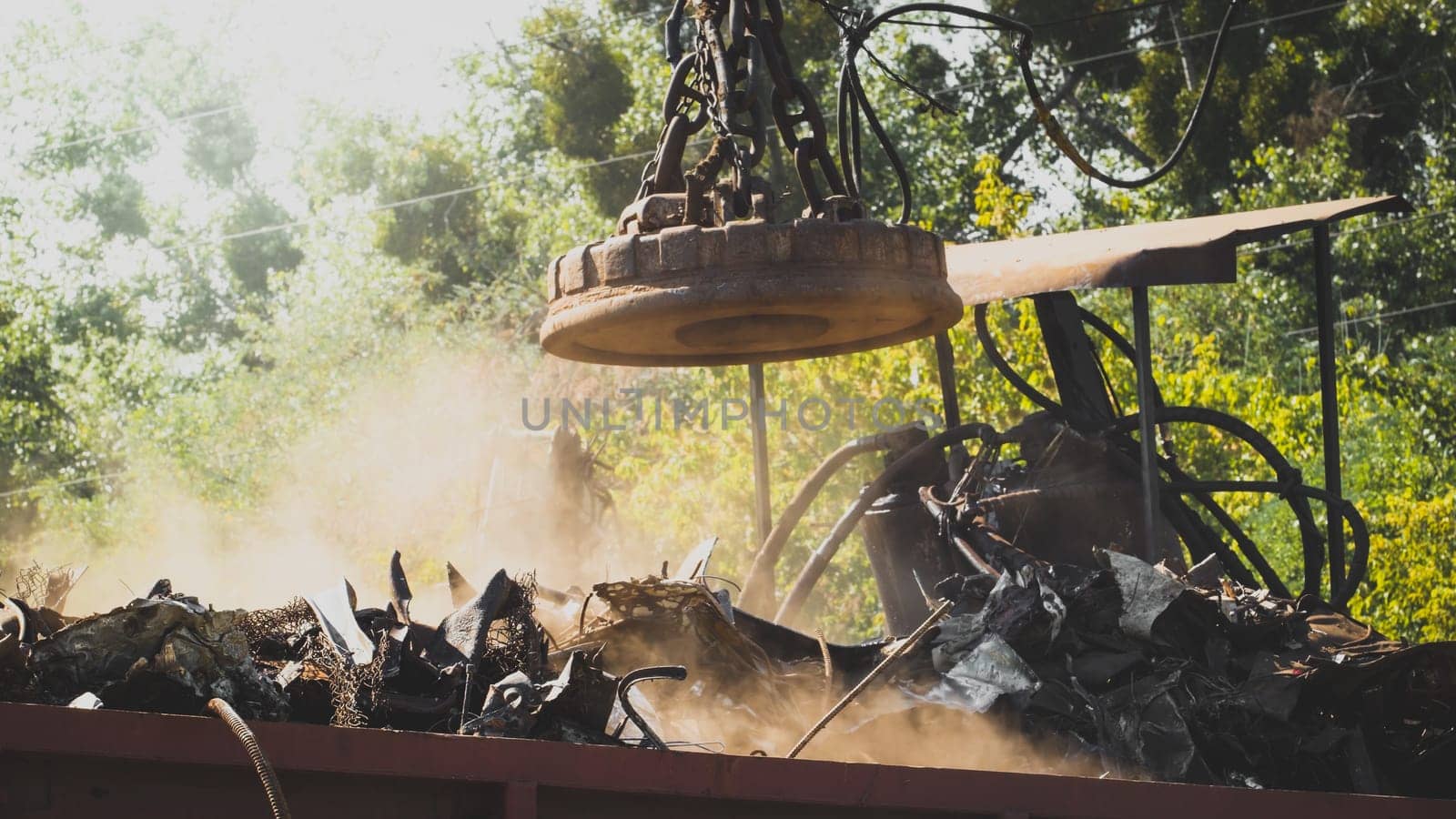 Toned photo of electric industrial magnet for sorting metal waste on the dump