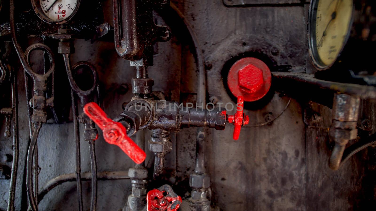 Closeup image of vintage gauges and valves at train steam engine