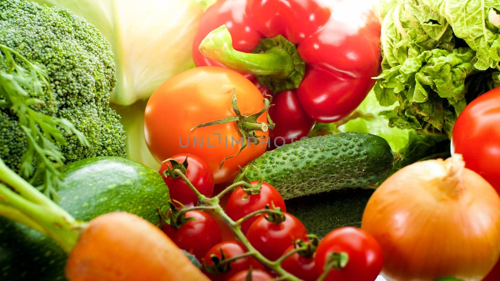 Background with sun shining on fresh ripe vegetables from garden lyign on table