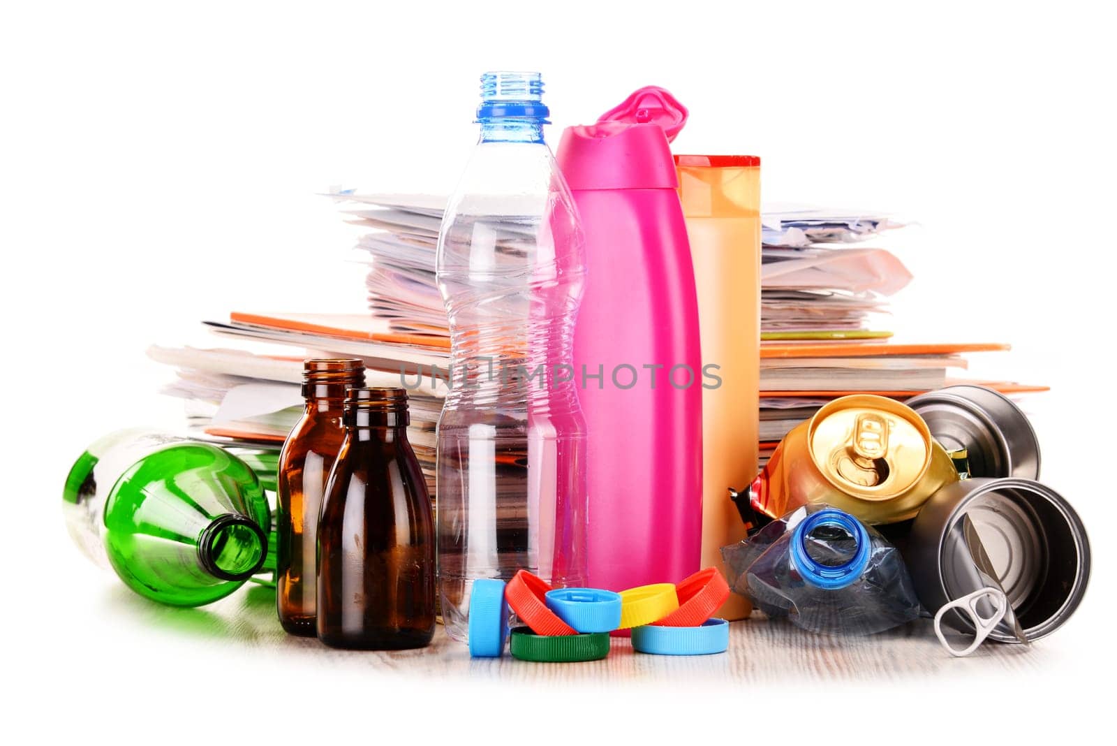 Recyclable garbage consisting of glass, plastic, metal and paper isolated on white background