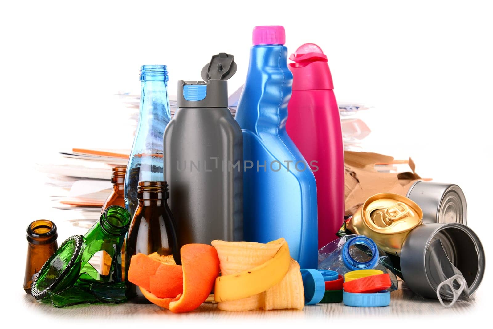 Recyclable garbage consisting of glass, plastic, metal and paper isolated on white background