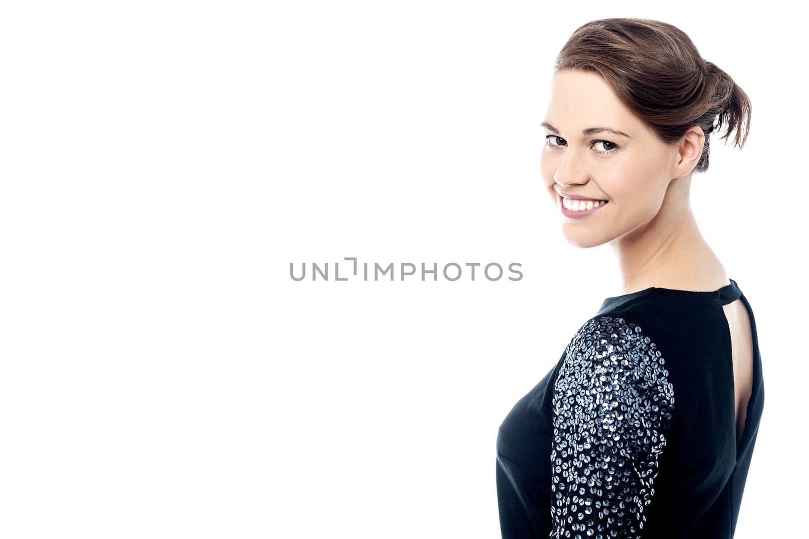 Stylish woman looking back and posing at camera.