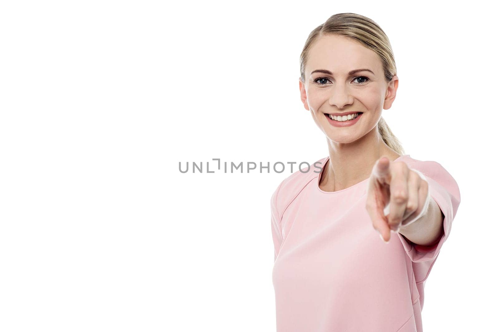 Smiling young girl pointing towards you