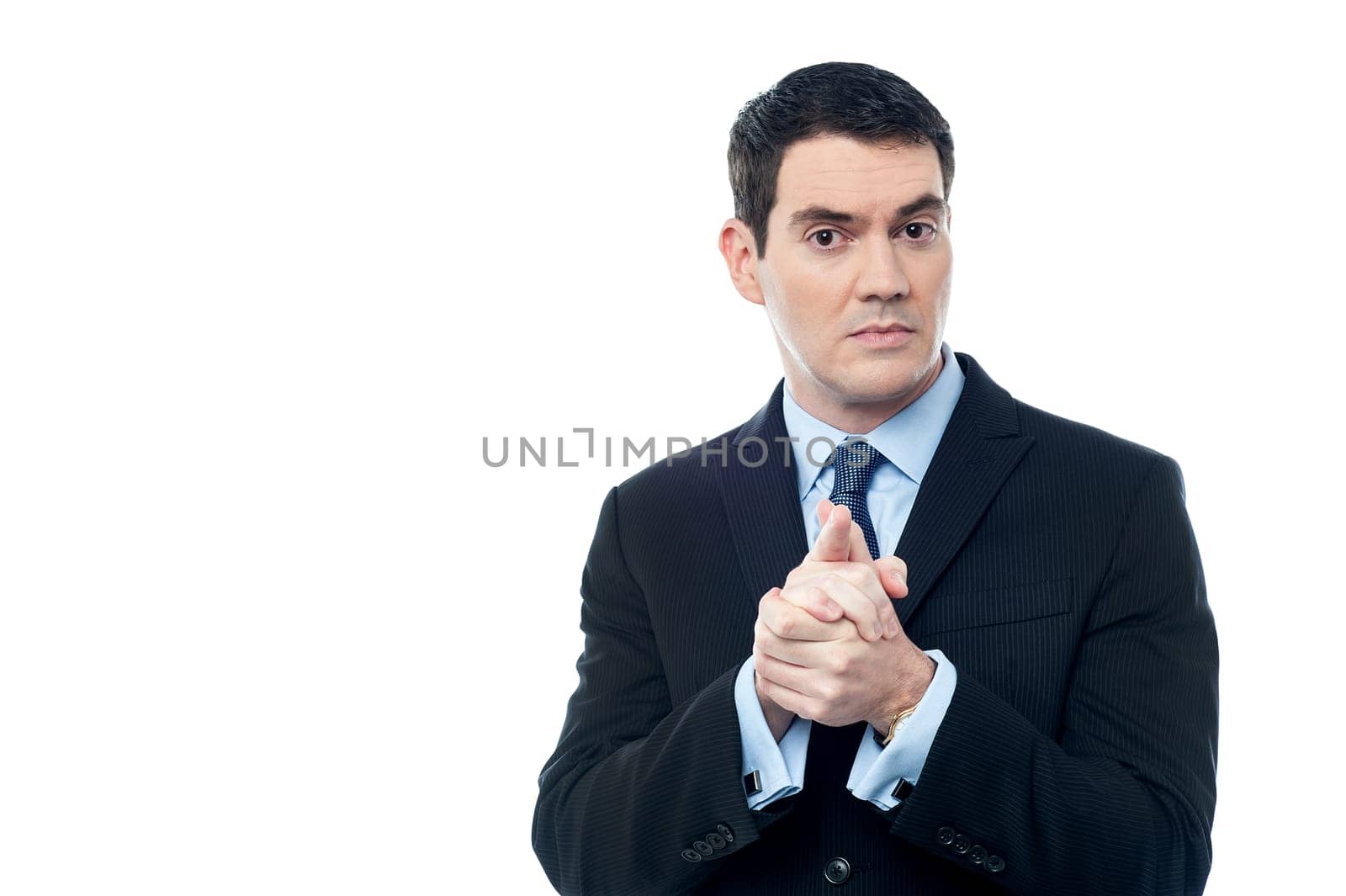 Confident businessman holding his hands clasped