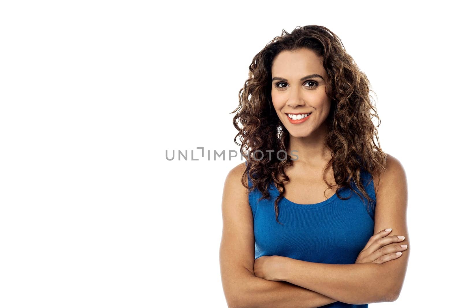 Smiling young woman posing with folded arms
